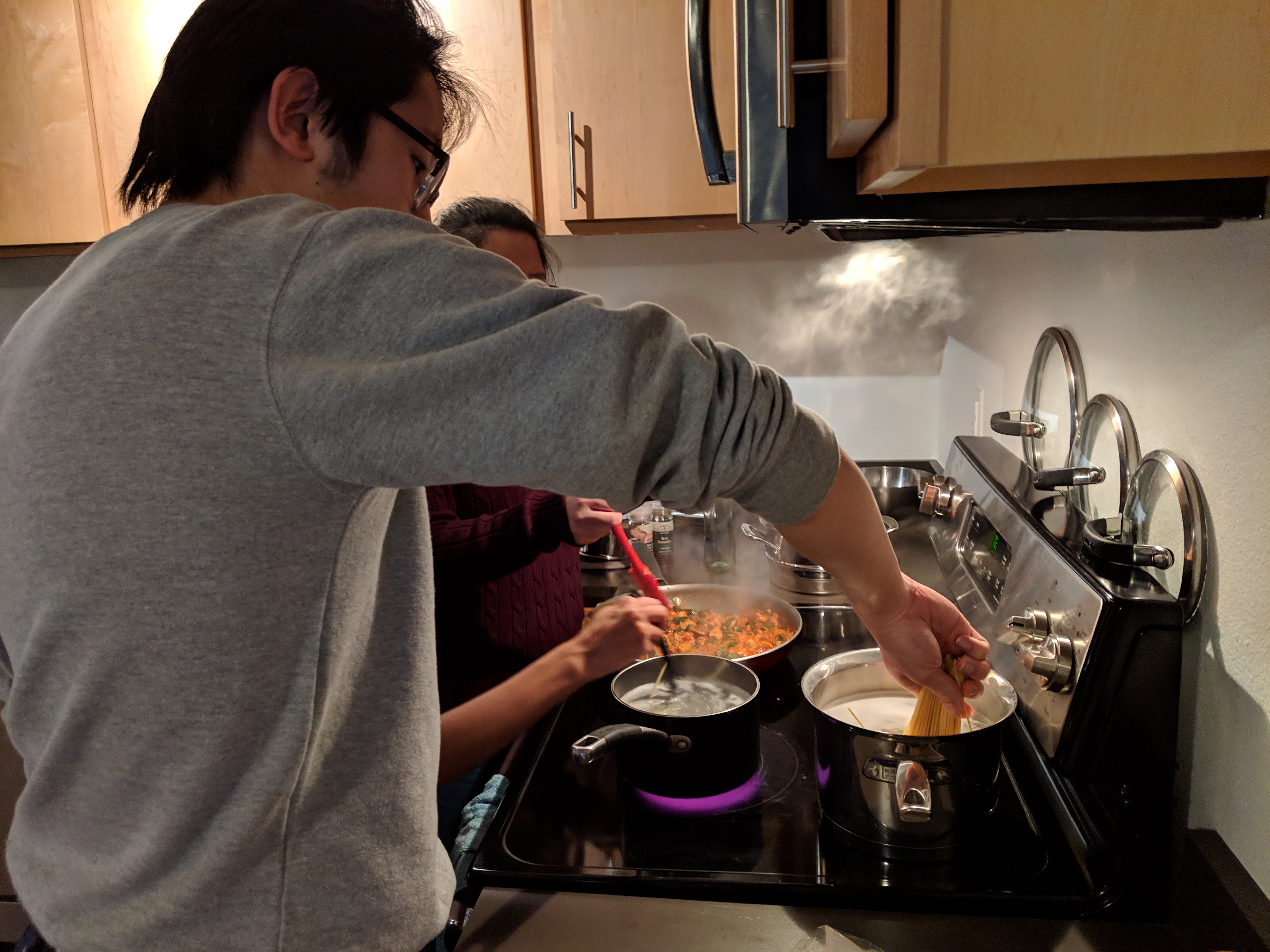 Alex cooking pasta without breaking it.