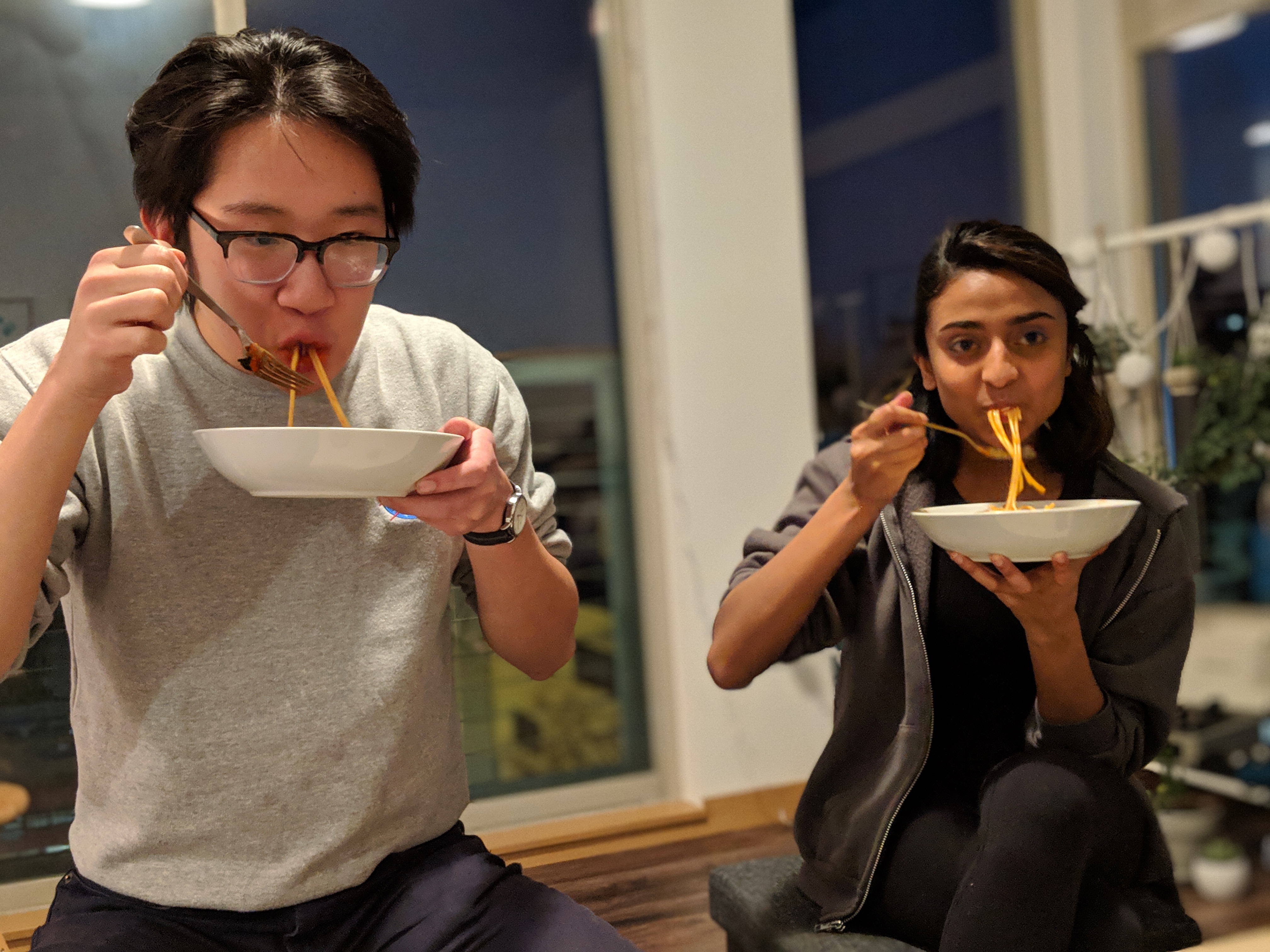 Alex and Vishaka eating spaghetti.